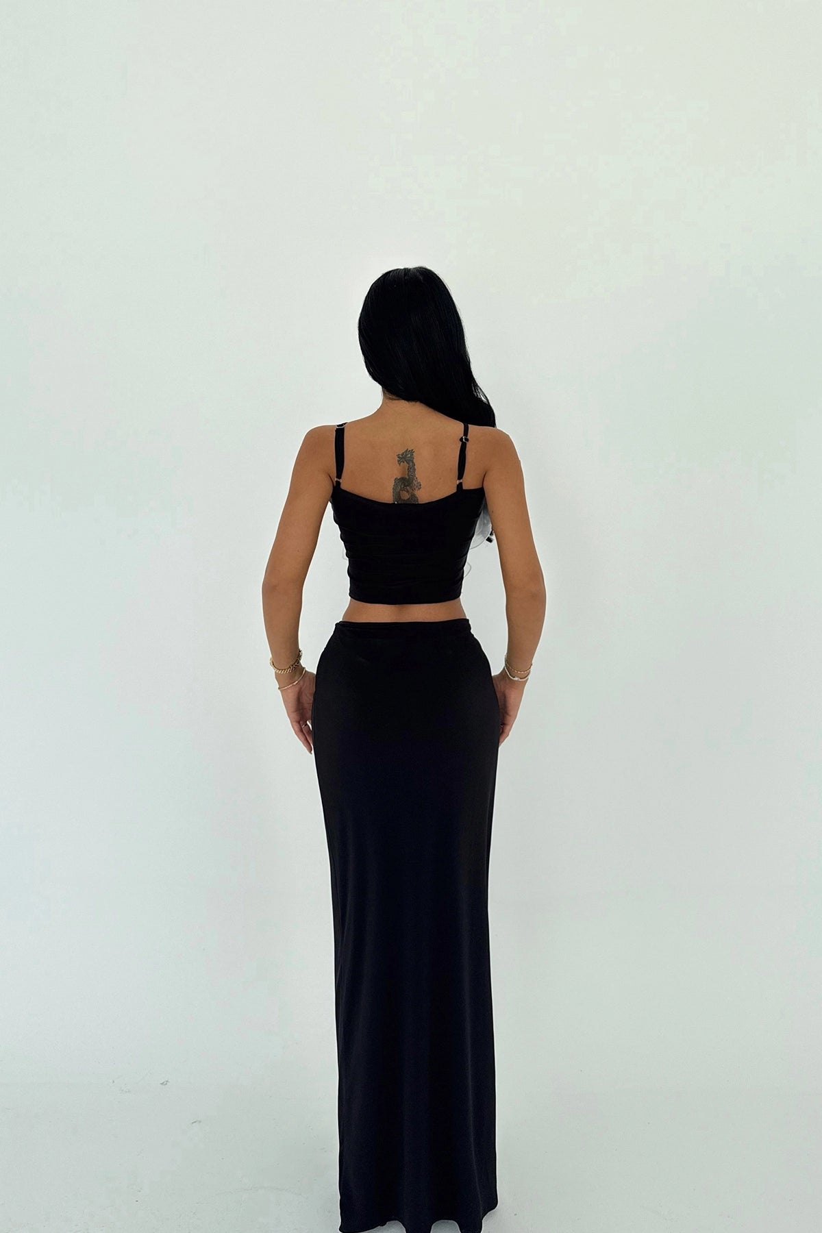 Back view of Rose Set with black maxi skirt and adjustable crop top