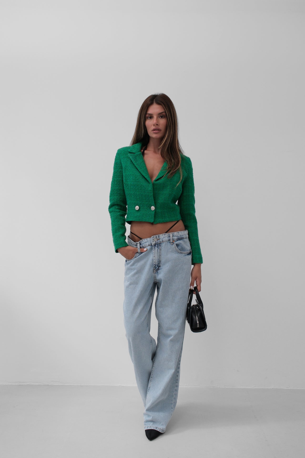 Model wearing emerald cropped bouclé blazer with silver buttons – LARYVOE women’s jacket