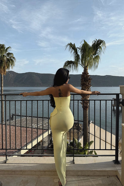 Back view of yellow strapless evening gown with rose detail – LARYVOE dress