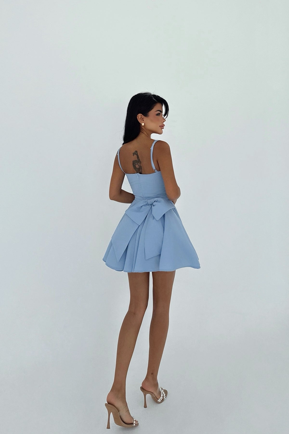 Back view of blue skater dress with oversized bow detail – LARYVOE clothing